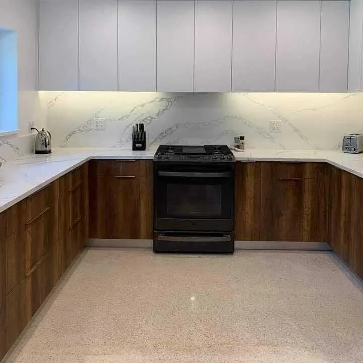 Custom kitchen remodel with wood cabinetry and marble countertops